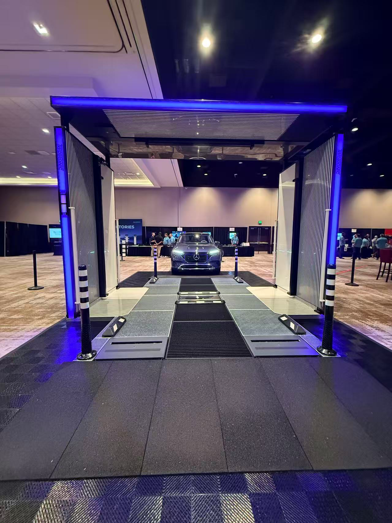 TwoTronic automated drive-through vehicle inspection scanner machine portal with vehicle undergoing diagnostic lane scanning